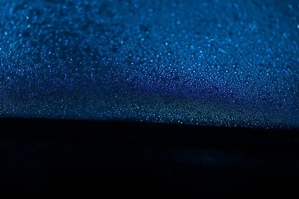 Rain Drops On Blue and black background Glass. Background with bokeh. — Stock Photo, Image