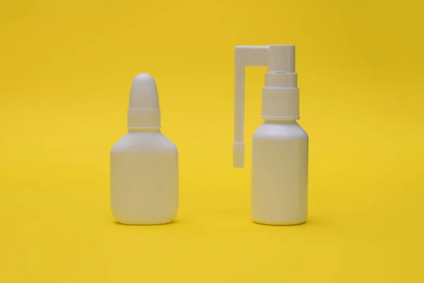 Nasal spray and throat spray close-up. Medicines for flu and colds.