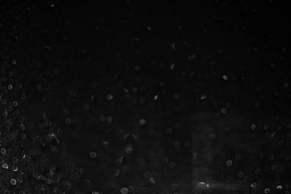 Texture blurred bokeh drops on a black background. Disfocused. — Stock Photo, Image