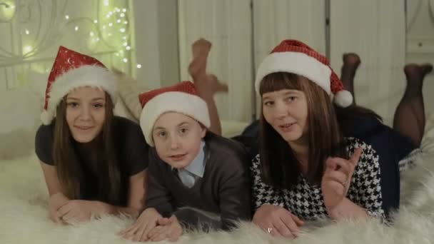 Family, mother, son and daughter in red caps — Stock Video