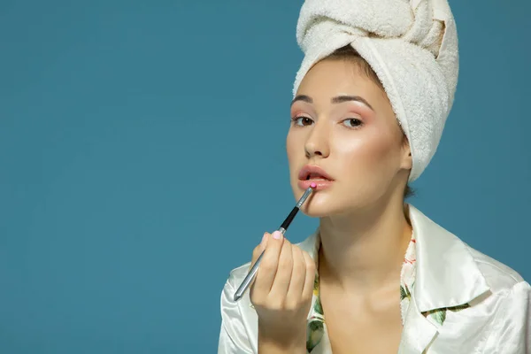 Young Attractive Girl Putting Pink Lipstick Lips Studio Shot Blue — Stock Photo, Image