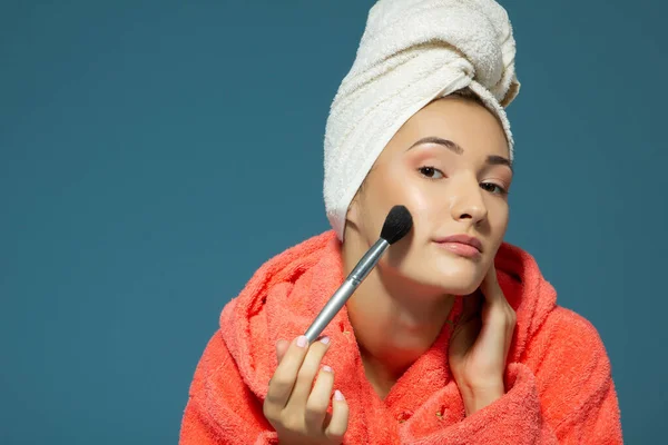 Young Attractive Woman Putting Blush Her Cheekbones Blue Background Charming — Φωτογραφία Αρχείου