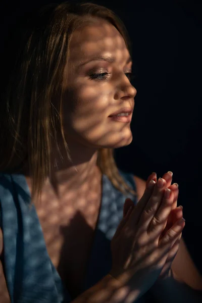美丽的女人在忏悔中忏悔 祈祷的女人 美术肖像与有趣的韧带和阴影图案 — 图库照片