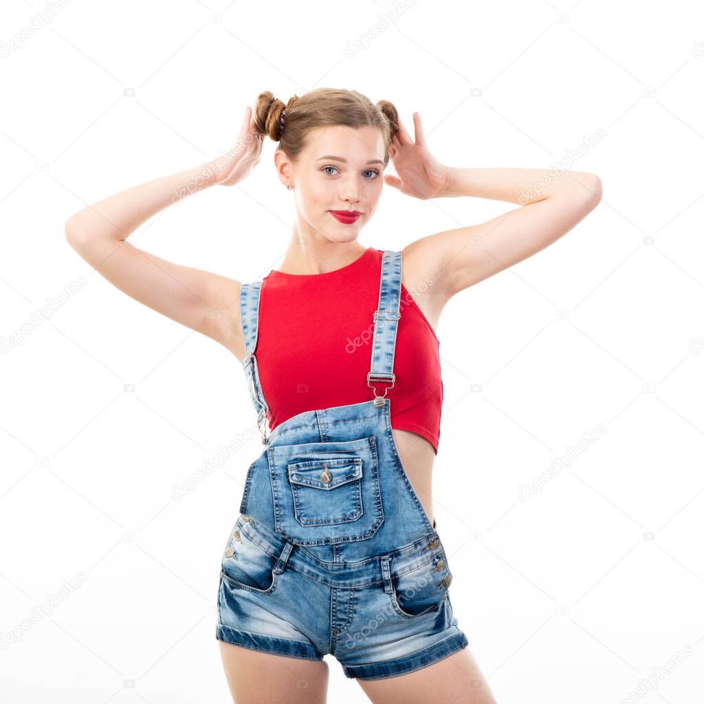 Pretty teen girl, portrait over white background. Beautiful woman wearing red top and blue jeans. Young charming lady with blue eyes and blond hair