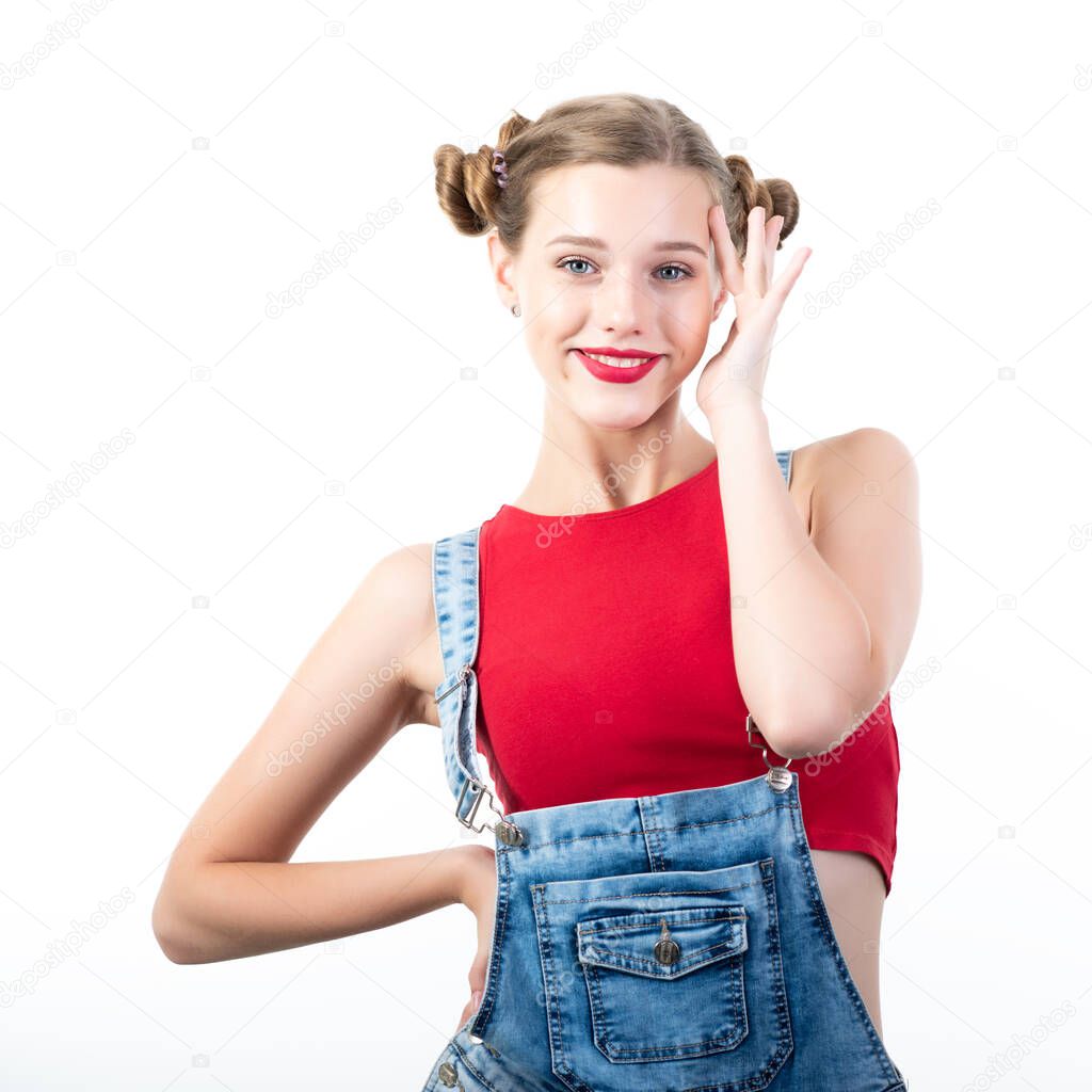 Pretty funny happy teen girl, portrait over white background. Beautiful woman wearing red top, blue jeans. Young charming lady with blue eyes and blond hair