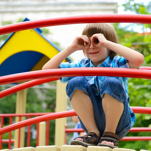 Garçon jouant sur aire de jeux — Photo