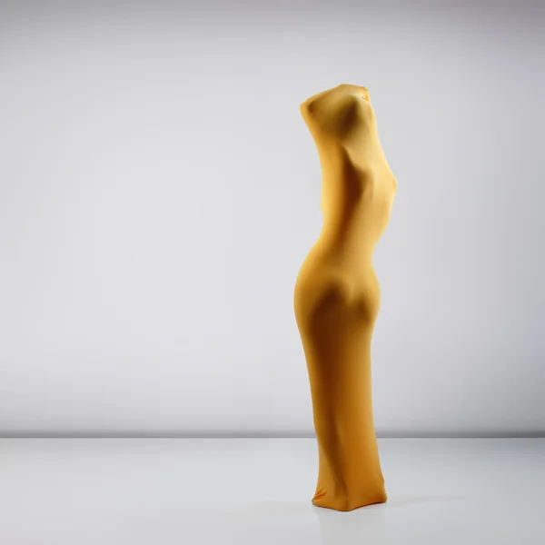 Female body in yellow fabric — Stock Photo, Image