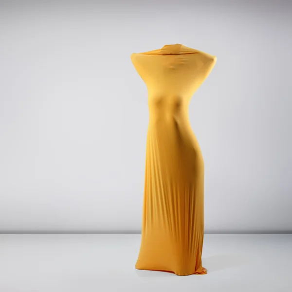 Female body in yellow fabric — Stock Photo, Image