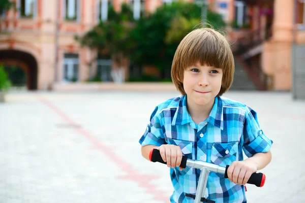 Boy riding  scooter — Stock Photo, Image