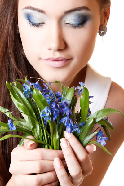 Teen girl smell snowdrop flowers