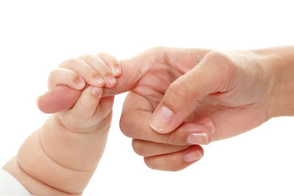 Baby holds mother's finger hand, — Stockfoto