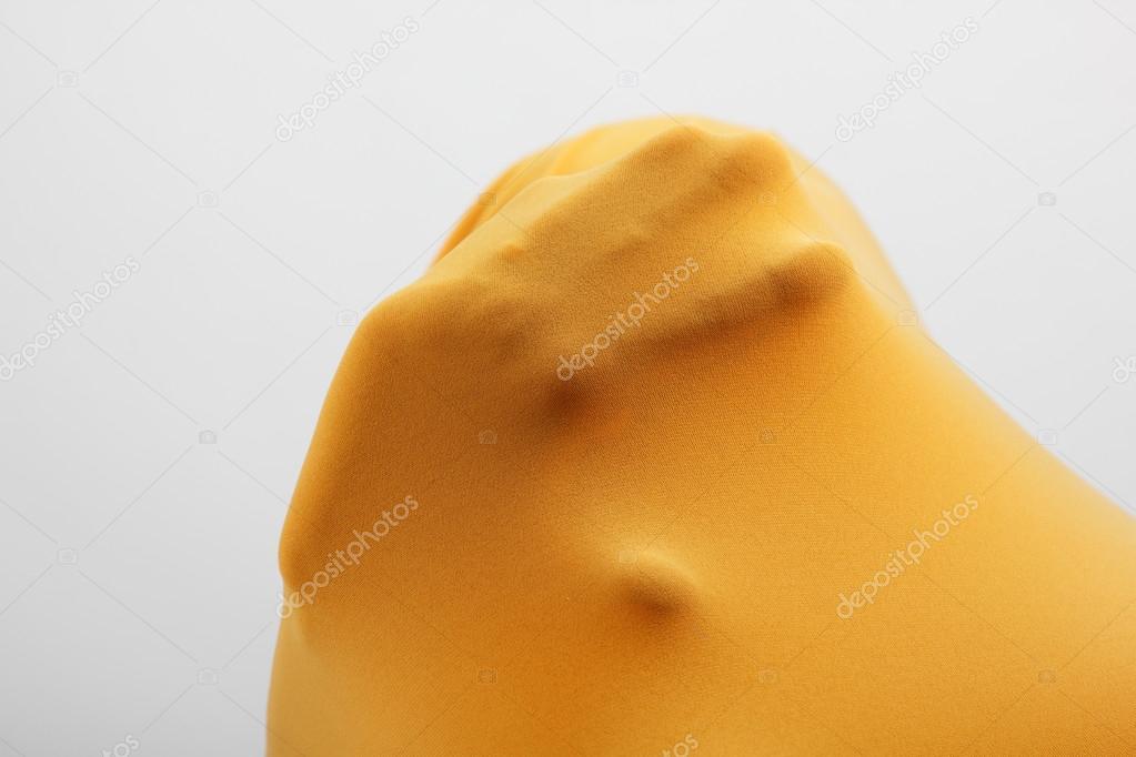 Abstract hands inside yellow fabric