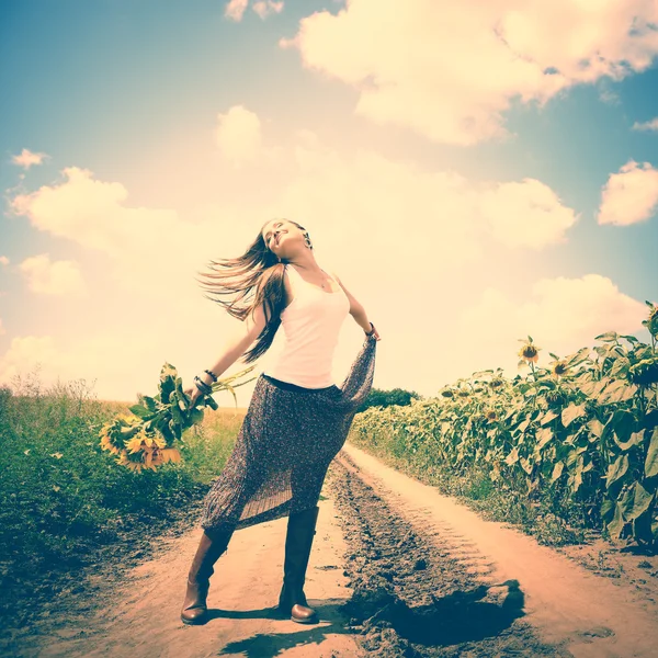Girl dancing with sunflowers — Stock Photo, Image