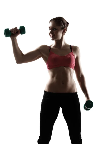 Spor kadın dumbbells ile egzersiz yaparak — Stok fotoğraf