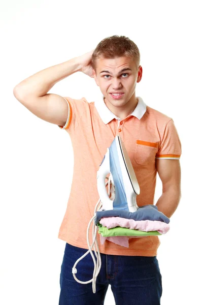 Displeased boy with iron and clothes — Stock Photo, Image