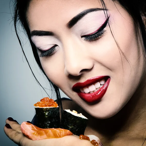 asian woman eating sushi