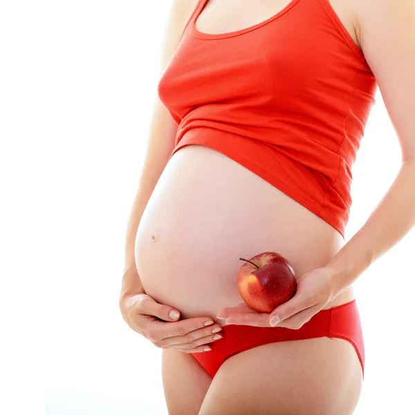 Kobieta w ciąży trzyma jabłko — Zdjęcie stockowe