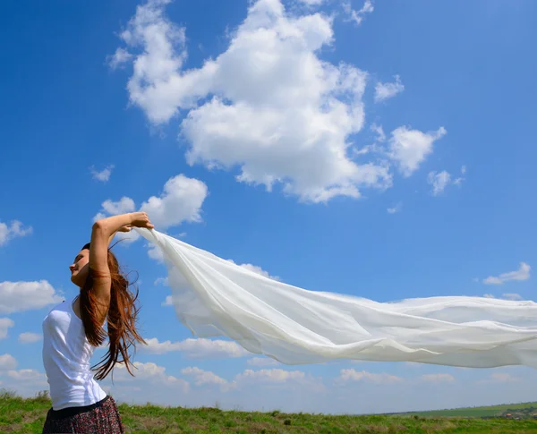 Woman holding white scarf on the field — Stock Photo, Image