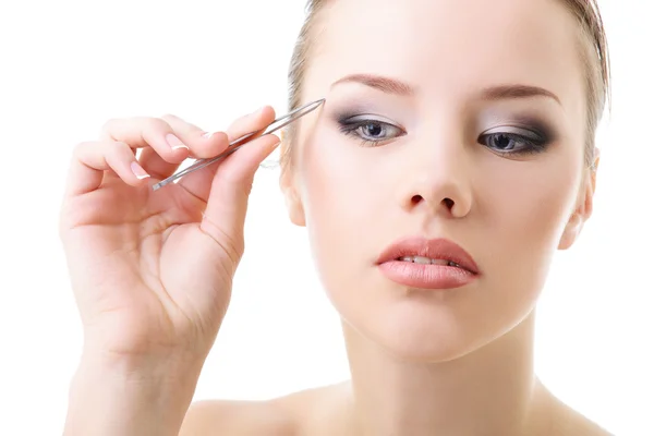 Girl plucking eyebrows — Stock Photo, Image