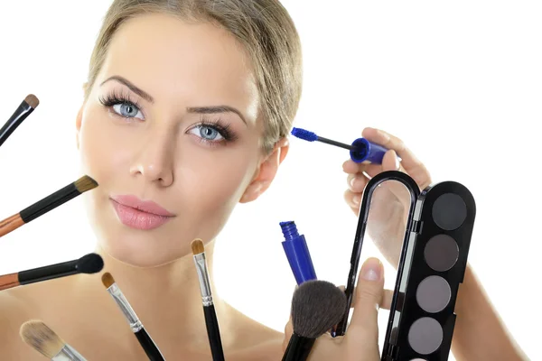 Woman with brushes and cosmetics — Stock Photo, Image