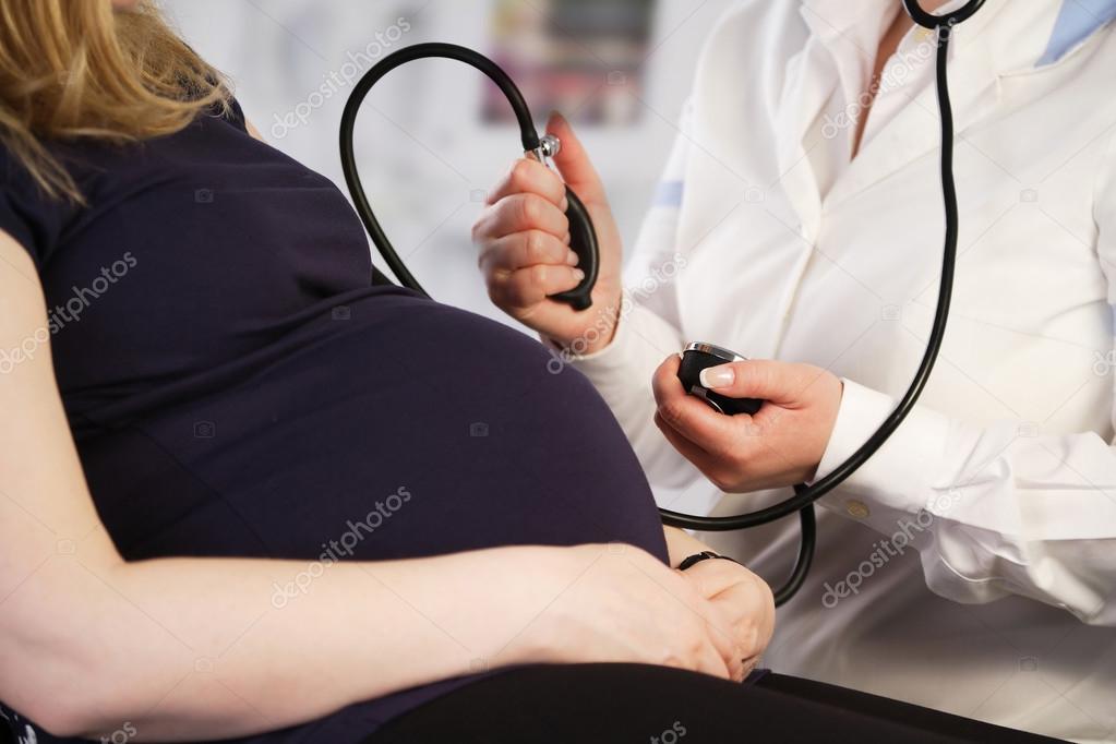 Pregnant woman having her blood pressure checked