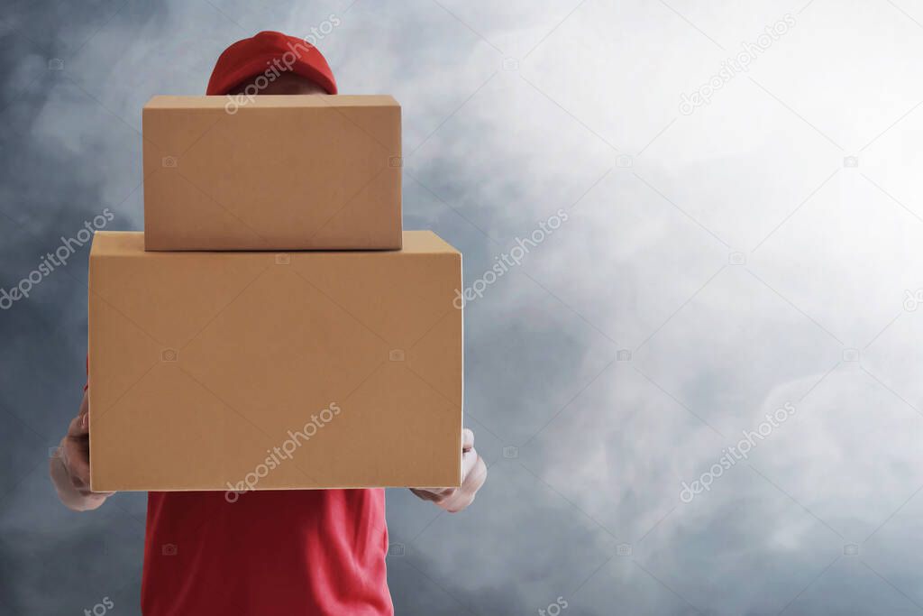 Delivery man holding cardboard box