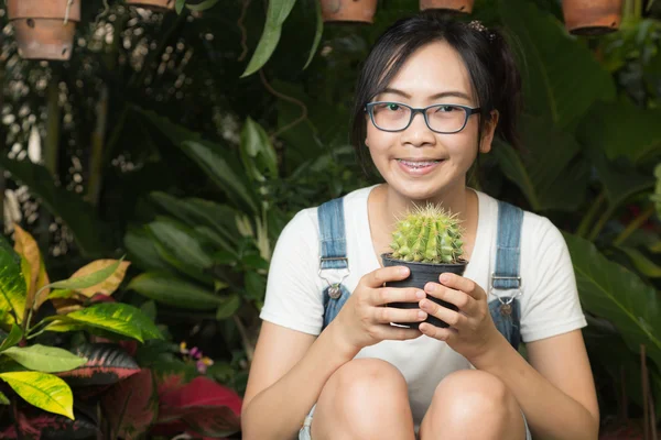 Woman holding a cactus — Stock Photo, Image