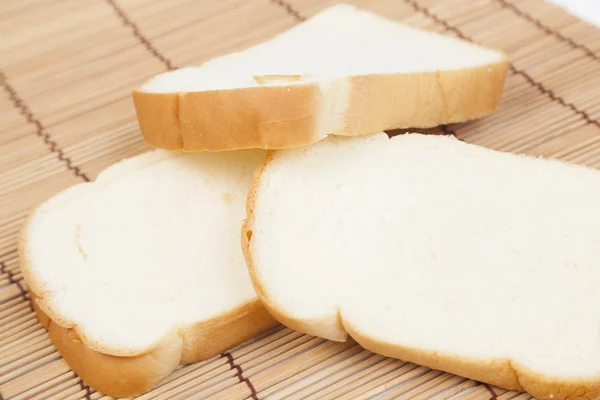 Sliced bread on the wooden plate. — Stock Photo, Image