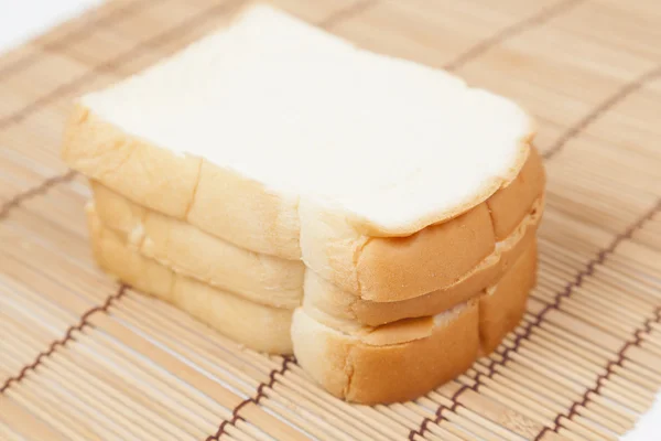 Sliced bread on the wooden plate. — Stock Photo, Image