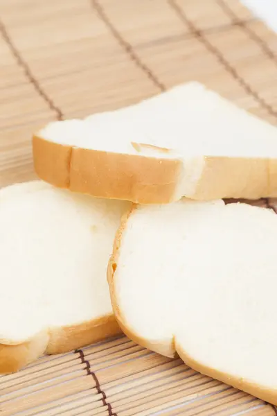 Sliced bread on the wooden plate. — Stock Photo, Image