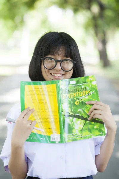 Young woman holding yellow book. — Stock Photo, Image