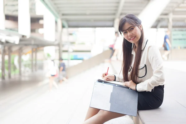 Happy businesswoman is writing. — Stock Photo, Image
