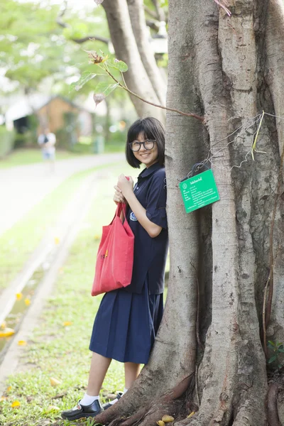 Girl wearing glasses a red holding the bag. — Stock Photo, Image