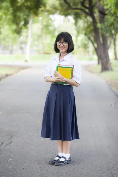 Liseli kız ayakta tutan bir kitap. — Stok fotoğraf