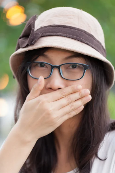 Asia woman hand shield mouth — Stock Photo, Image