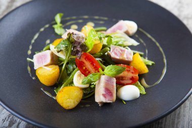 Kızarmış patates salatası, ton balığı, domates ve sos.