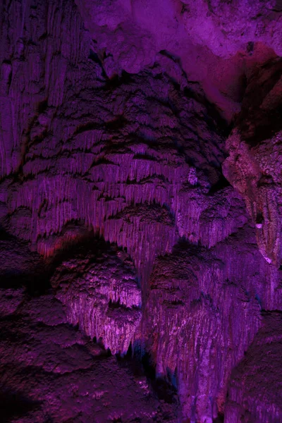 Stalactite and stalagmite formations in a limestone cave of Halong Bay, Vietnam