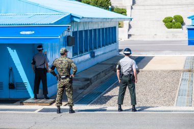 Korean soldiers watching border between South and North Korea in the Joint Security Area (DMZ) clipart