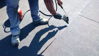 çatı ustası tarafından gaz Kalorifer meşale alevi erime için keçe rulo Çatı asfalt parçası hazırlama