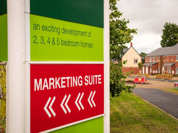 Marketing suite showroom sign over new build housing estate — Stock Photo, Image