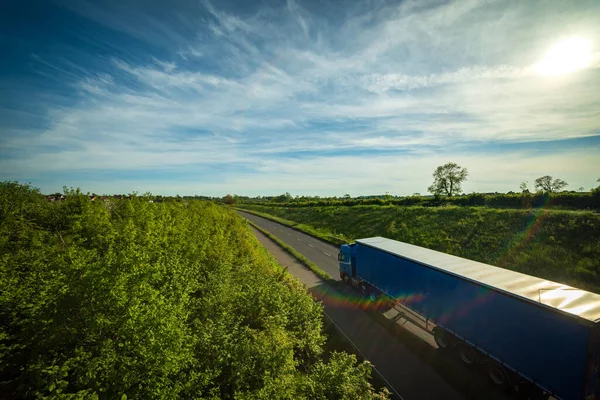 blue lorry truck on uk motorway road in england