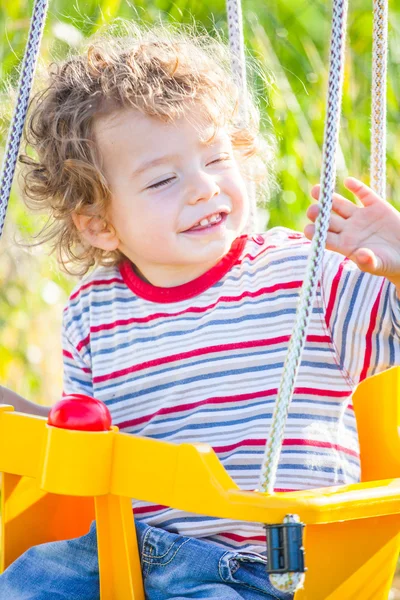 Baby boy in a swing — Stock Photo, Image