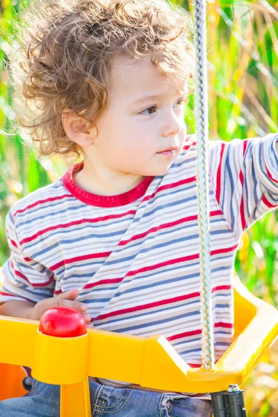 Baby boy in a swing — Stock Photo, Image