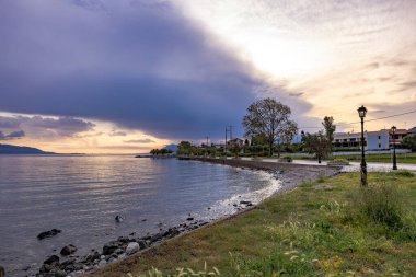 Orta Yunanistan 'daki Korint Körfezi' nde gün batımı Marathias köyünden ele geçirildi. Renkli gökyüzü, sakin deniz ve altın saat boyunca Akdeniz kıyıları. 