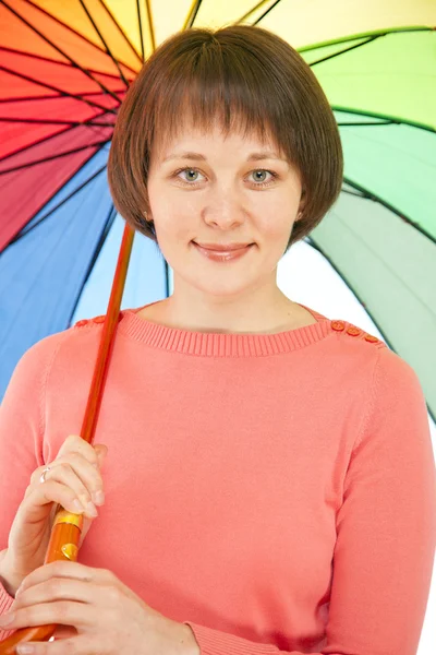 Ragazza in giacca rosa con ombrello a colori — Foto Stock