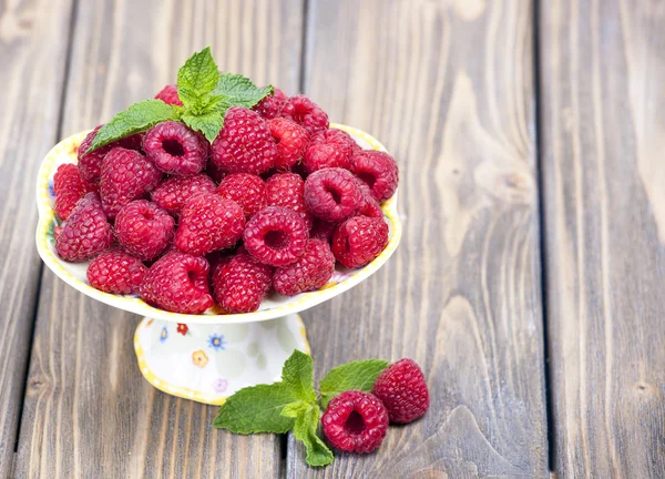 Raspberries on a wooden table — Stock Photo, Image