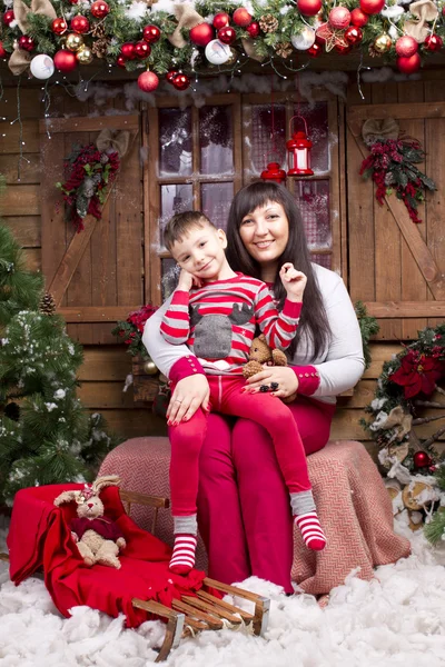 Boy with mother Christmas interior — Stock Photo, Image
