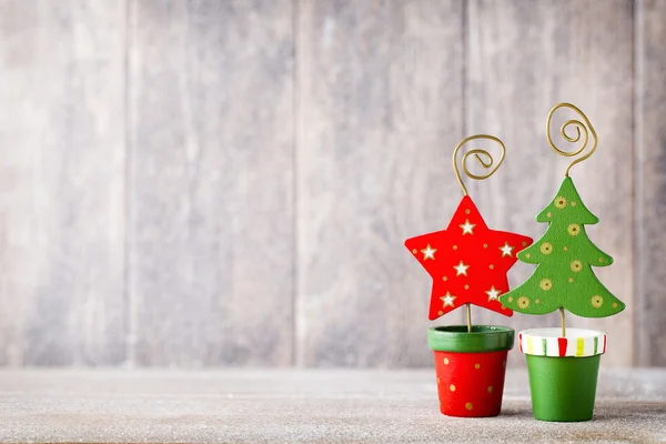 Artificial Christmas tree on a wooden background. — Stock Photo, Image
