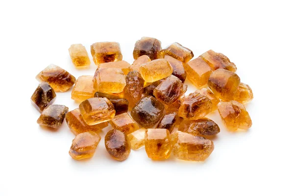 Large caramelized sugar on a white background. — Stock Photo, Image