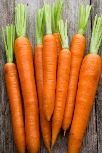 Свежая морковь на деревенском деревянном фоне. — стоковое фото